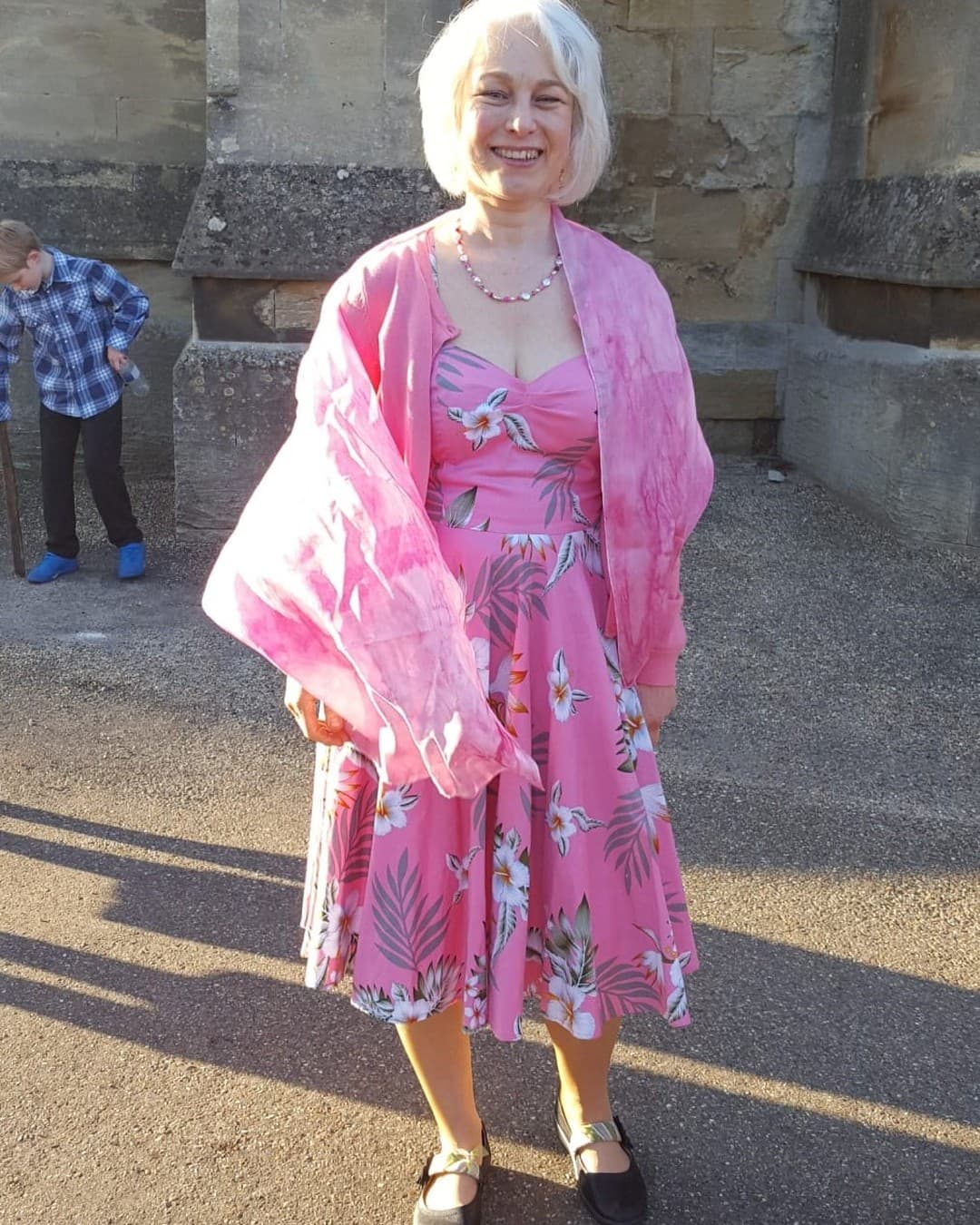 Client wearing a hand-painted pink silk stole with a floral wedding dress